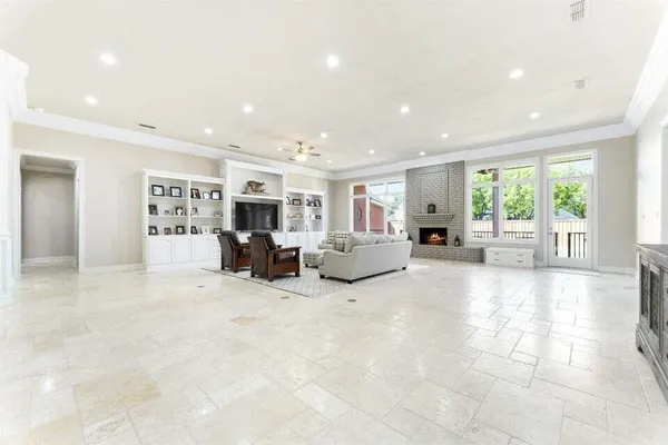 a living room with furniture large window and flat screen tv