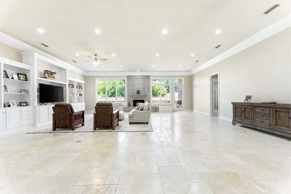 a living room with furniture a window and a potted plant