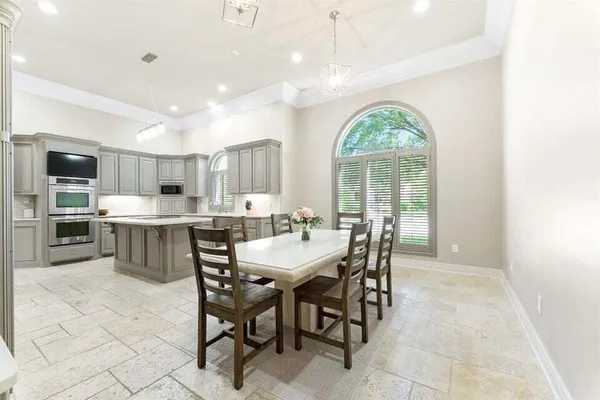 a large bathroom with a large window and chairs