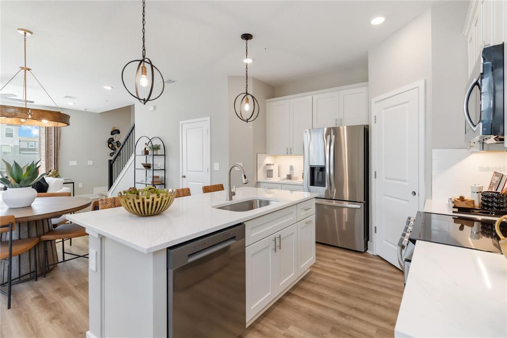 1081 Orange Trailside Way Ocoee, FL 34761 - Photo 2 of 29 a kitchen with sink refrigerator and cabinets