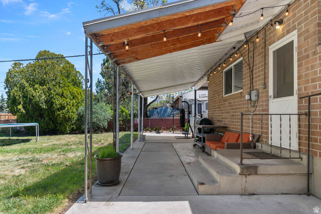 9902 South Poppy Lane Sandy, UT 84094 - Photo 21 of 25 Covered patio extending across the brick exterior