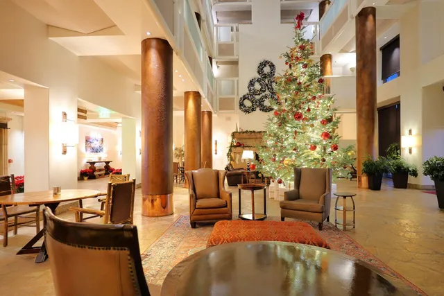 a living room with fireplace furniture and a potted plant