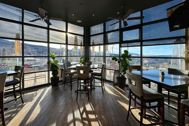 a dining room with furniture and wooden floor