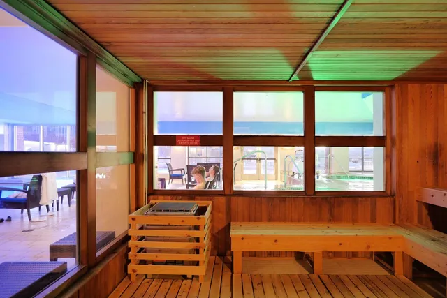 a bedroom with furniture and large windows