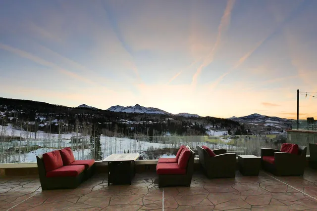 a view of a terrace with couches and lounge chairs