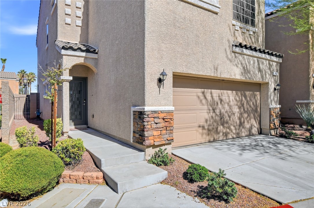 48 Jasmine Point Street Henderson, NV 89074 - Photo 60 of 62 A welcoming entry, complemented by manicured landscaping, beckons you inside this residence.