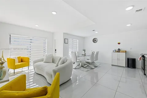 a living room with furniture and white walls