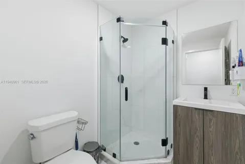 a bathroom with a shower toilet and sink