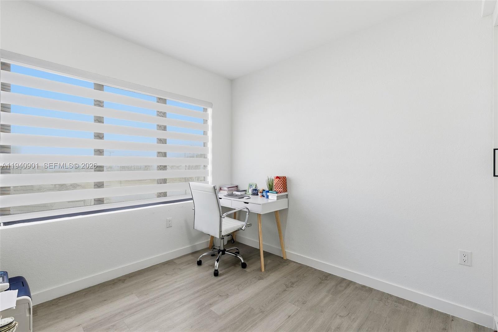 26122 Southwest 145th Court Homestead, FL 33033 - Photo 17 of 54 a view of a workspace with wooden floor and a cabinet