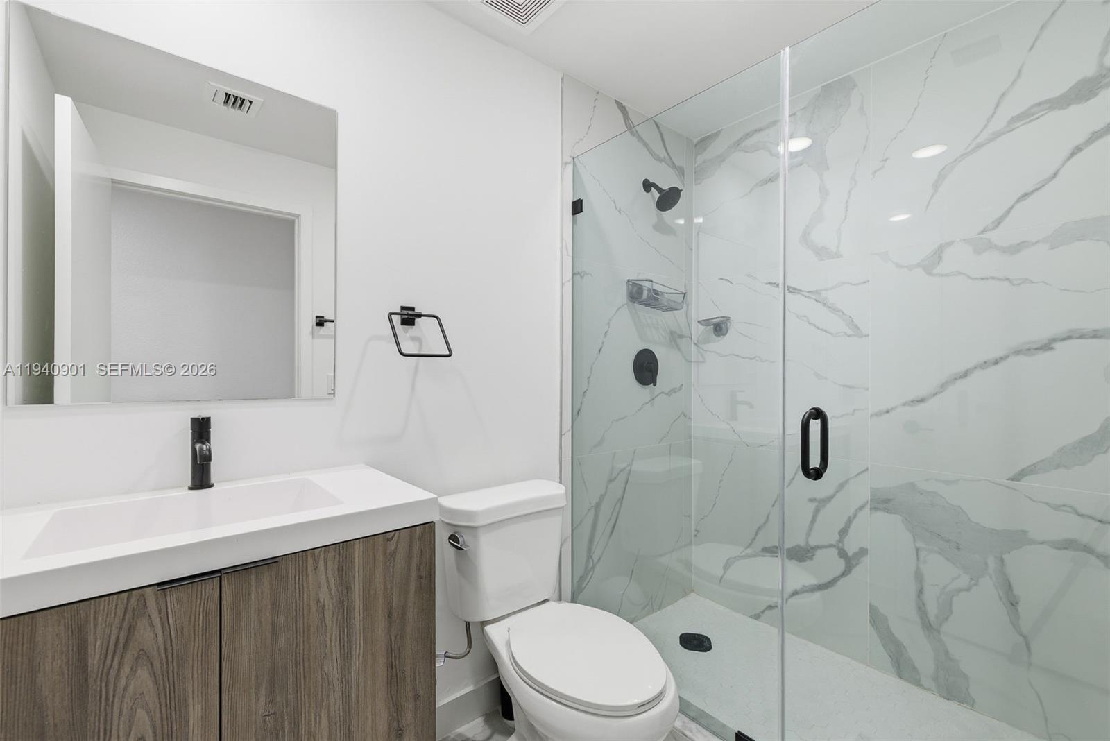 26122 Southwest 145th Court Homestead, FL 33033 - Photo 18 of 54 a bathroom with a sink a toilet and shower