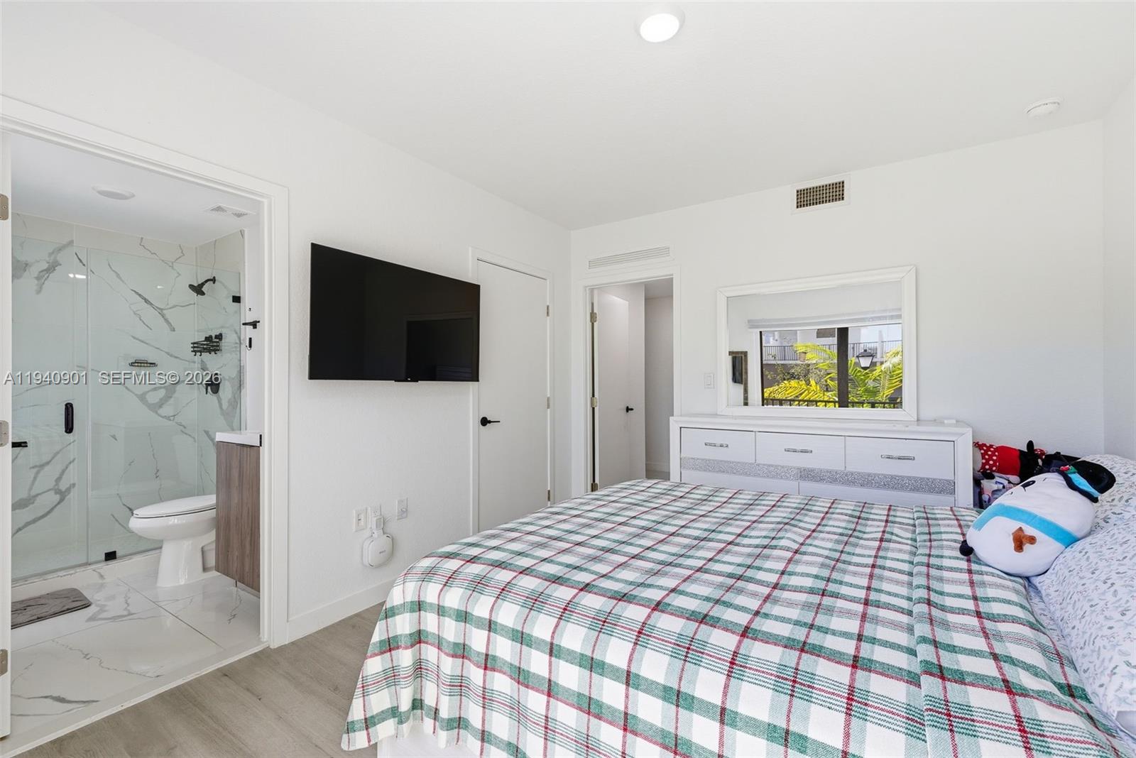 26122 Southwest 145th Court Homestead, FL 33033 - Photo 22 of 54 a bedroom with a bed and a flat screen tv