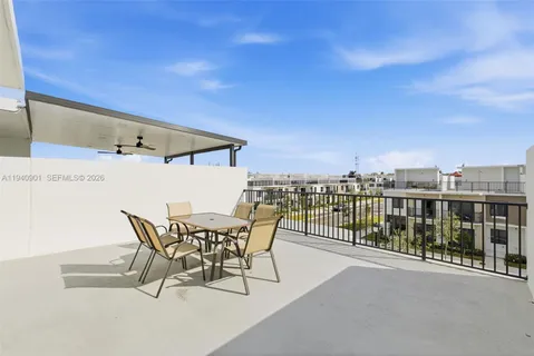 a view of a terrace with furniture and city view