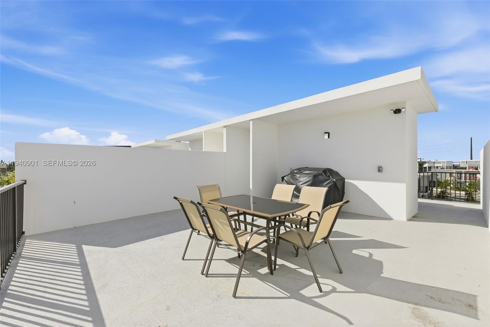 26122 Southwest 145th Court Homestead, FL 33033 - Photo 31 of 54 a view of a patio with table and chairs with wooden floor