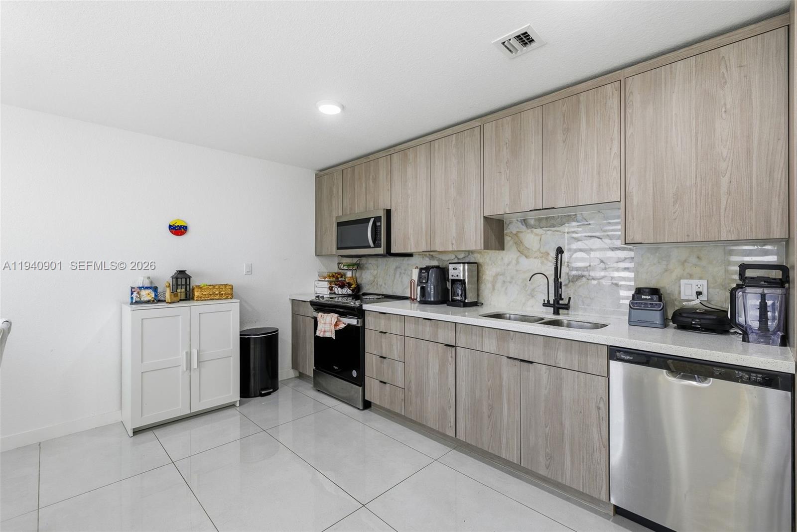 26122 Southwest 145th Court Homestead, FL 33033 - Photo 4 of 54 a kitchen with cabinets and white appliances