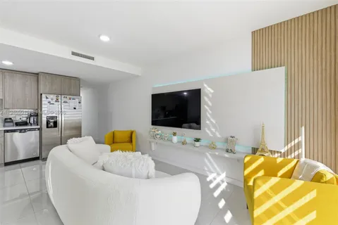 a bedroom with a bed and flat screen tv