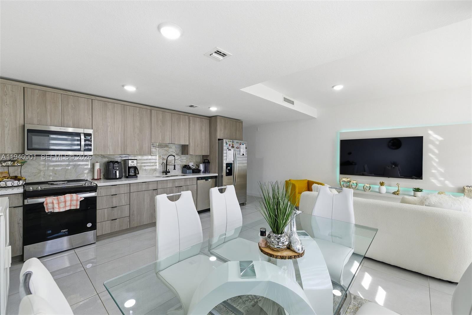 26122 Southwest 145th Court Homestead, FL 33033 - Photo 9 of 54 a living room with stainless steel appliances furniture and a flat screen tv