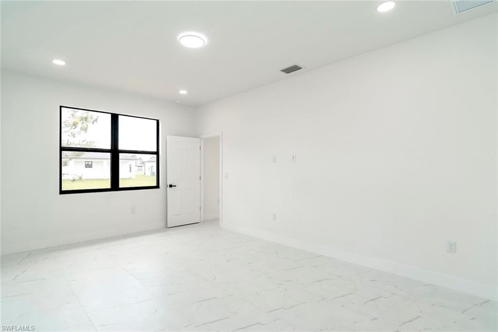 3810 29th Street Southwest Lehigh Acres, FL 33976 - Photo 15 of 48 an empty room with windows