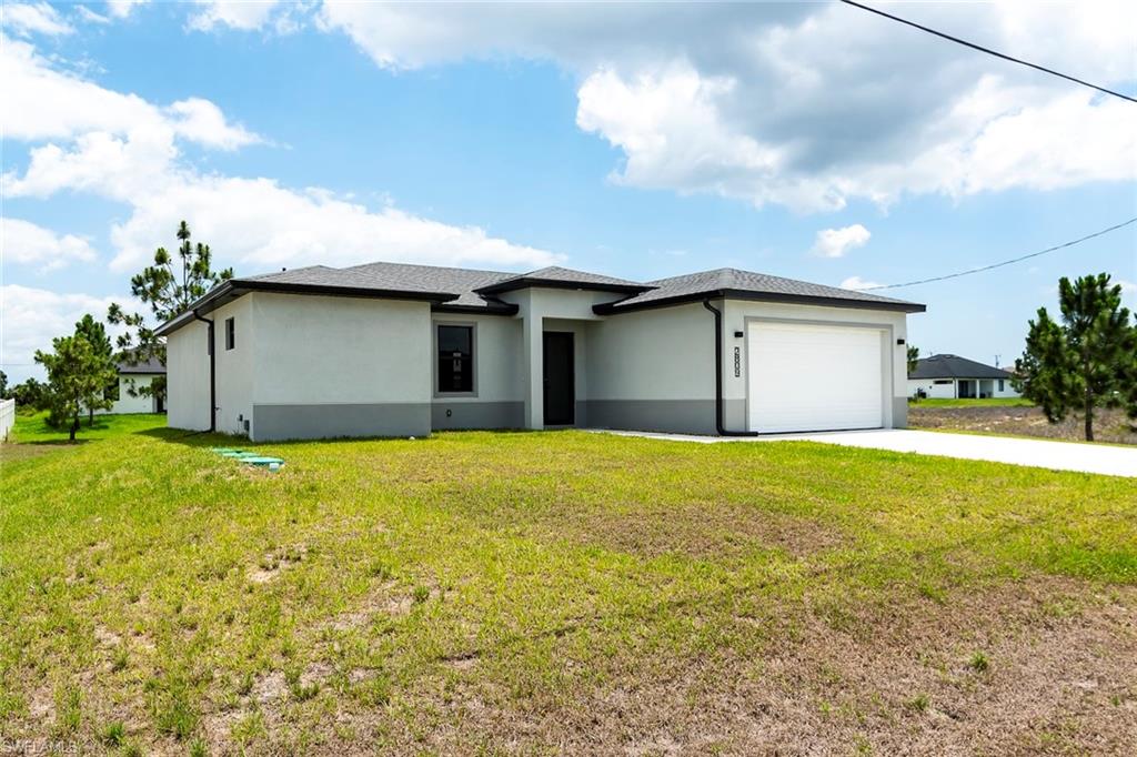 3810 29th Street Southwest Lehigh Acres, FL 33976 - Photo 2 of 48 a house view with a garden space