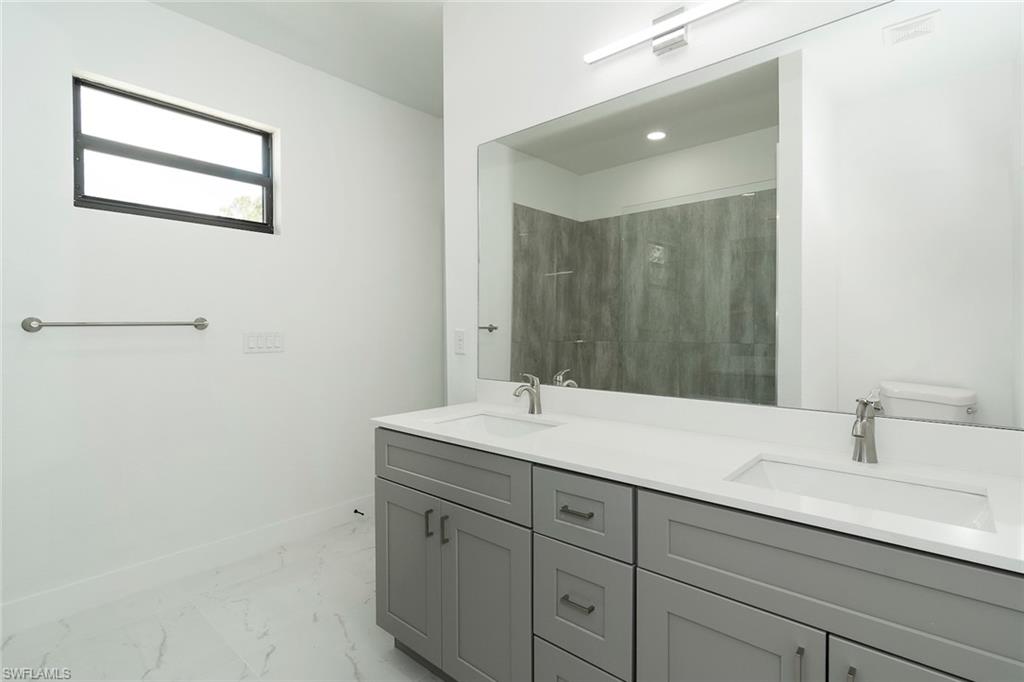 3810 29th Street Southwest Lehigh Acres, FL 33976 - Photo 20 of 48 a bathroom with a sink and a mirror