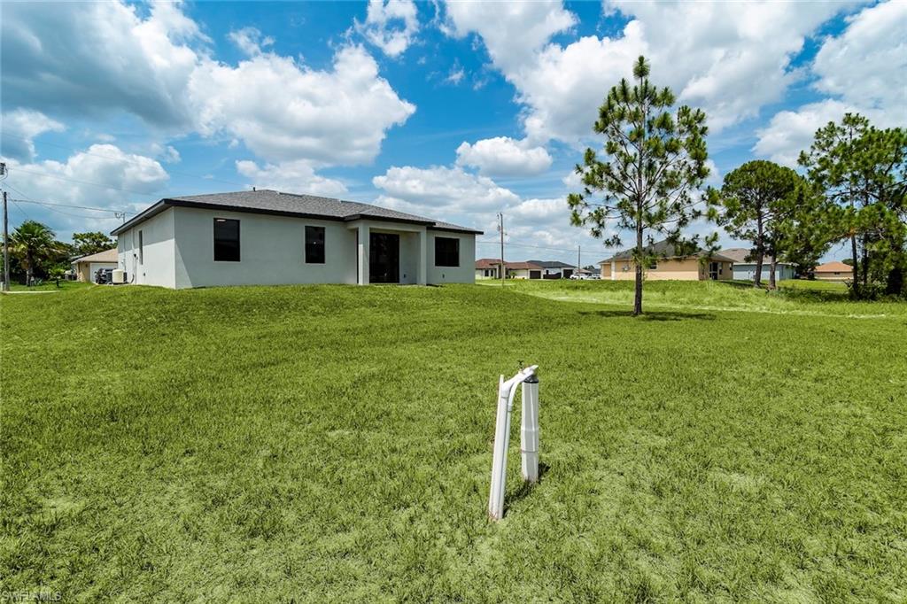 3810 29th Street Southwest Lehigh Acres, FL 33976 - Photo 22 of 48 a house view with a garden space