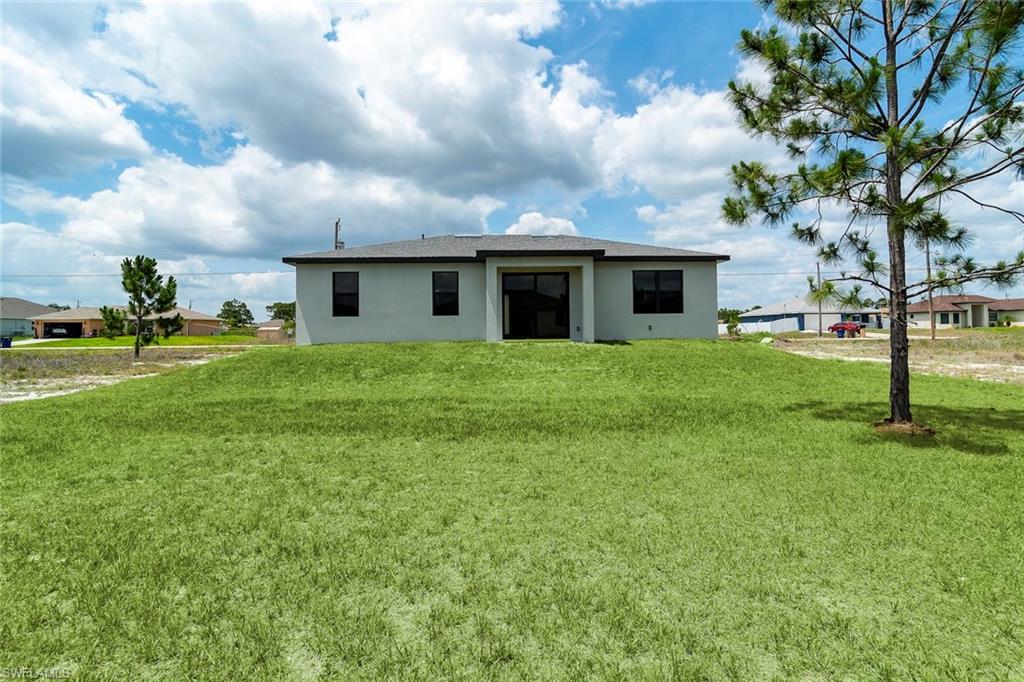 3810 29th Street Southwest Lehigh Acres, FL 33976 - Photo 23 of 48 a view of a house with a yard