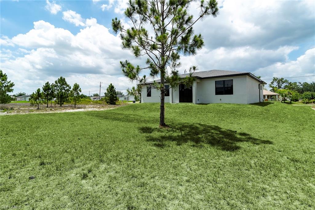 3810 29th Street Southwest Lehigh Acres, FL 33976 - Photo 24 of 48 a front view of a house with garden
