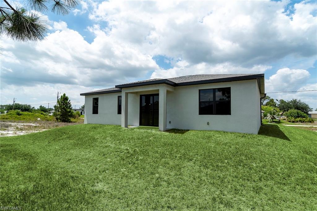 3810 29th Street Southwest Lehigh Acres, FL 33976 - Photo 25 of 48 a view of a house with backyard and garden