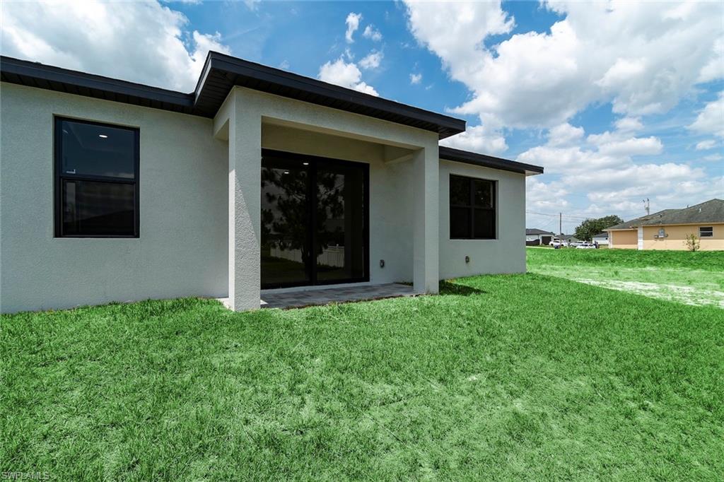 3810 29th Street Southwest Lehigh Acres, FL 33976 - Photo 26 of 48 a view of a house with backyard