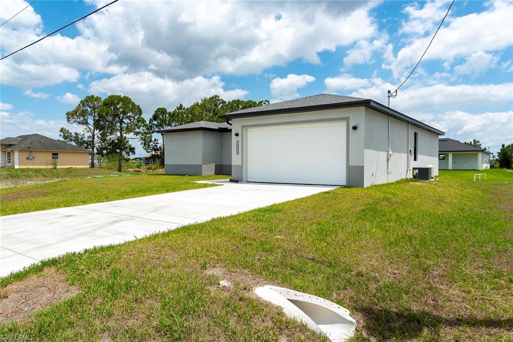 3810 29th Street Southwest Lehigh Acres, FL 33976 - Photo 3 of 48 a house view with a big yard and large trees