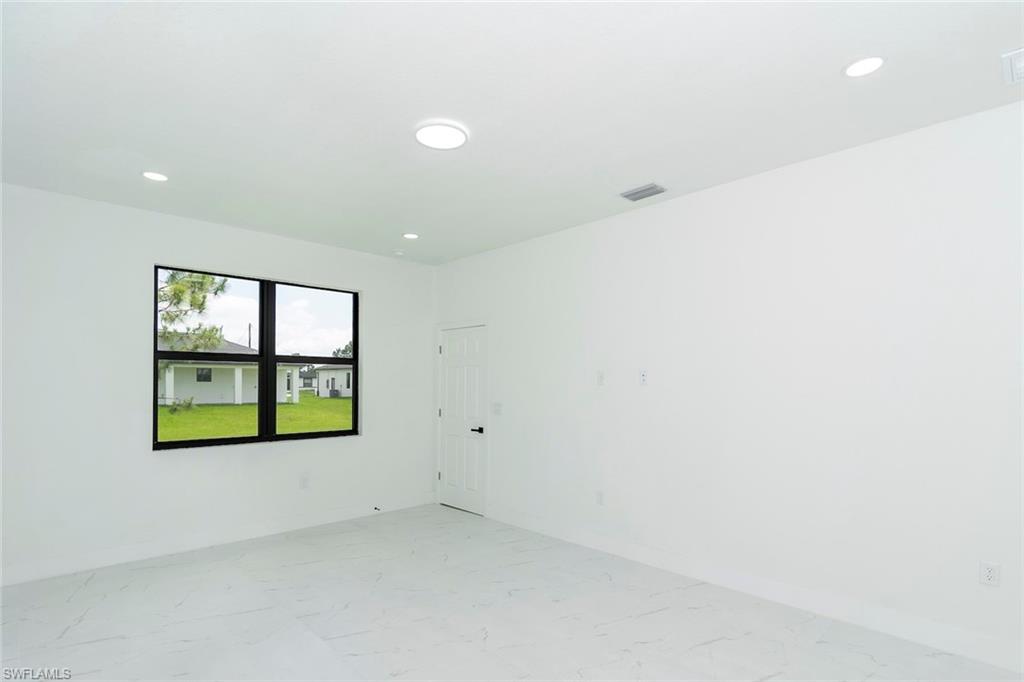 3810 29th Street Southwest Lehigh Acres, FL 33976 - Photo 30 of 48 an empty room with windows