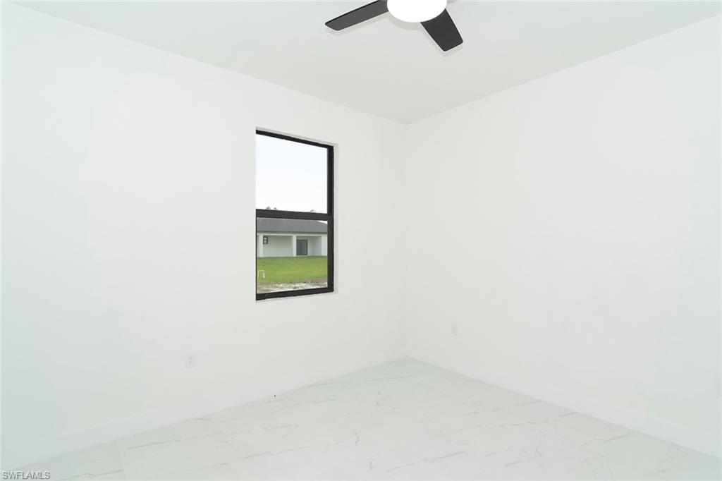 3810 29th Street Southwest Lehigh Acres, FL 33976 - Photo 35 of 48 a picture of a wall with a window