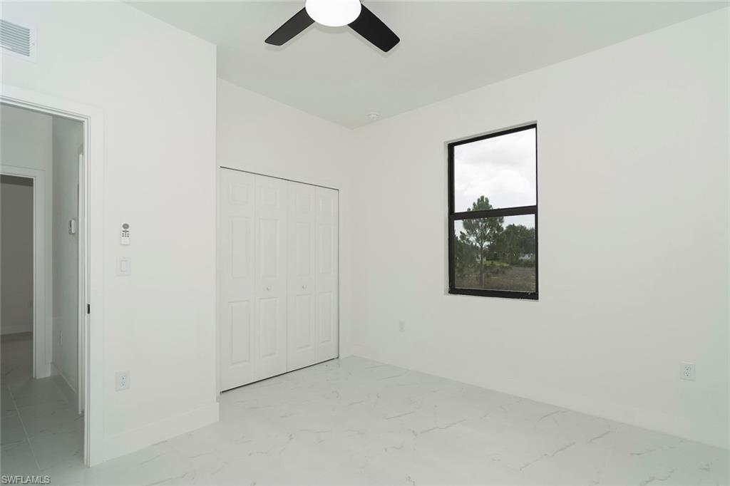 3810 29th Street Southwest Lehigh Acres, FL 33976 - Photo 41 of 48 an empty room with windows and cabinet