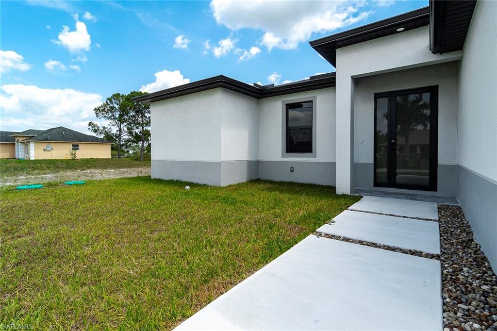 3810 29th Street Southwest Lehigh Acres, FL 33976 - Photo 47 of 48 a house with garden in front of it
