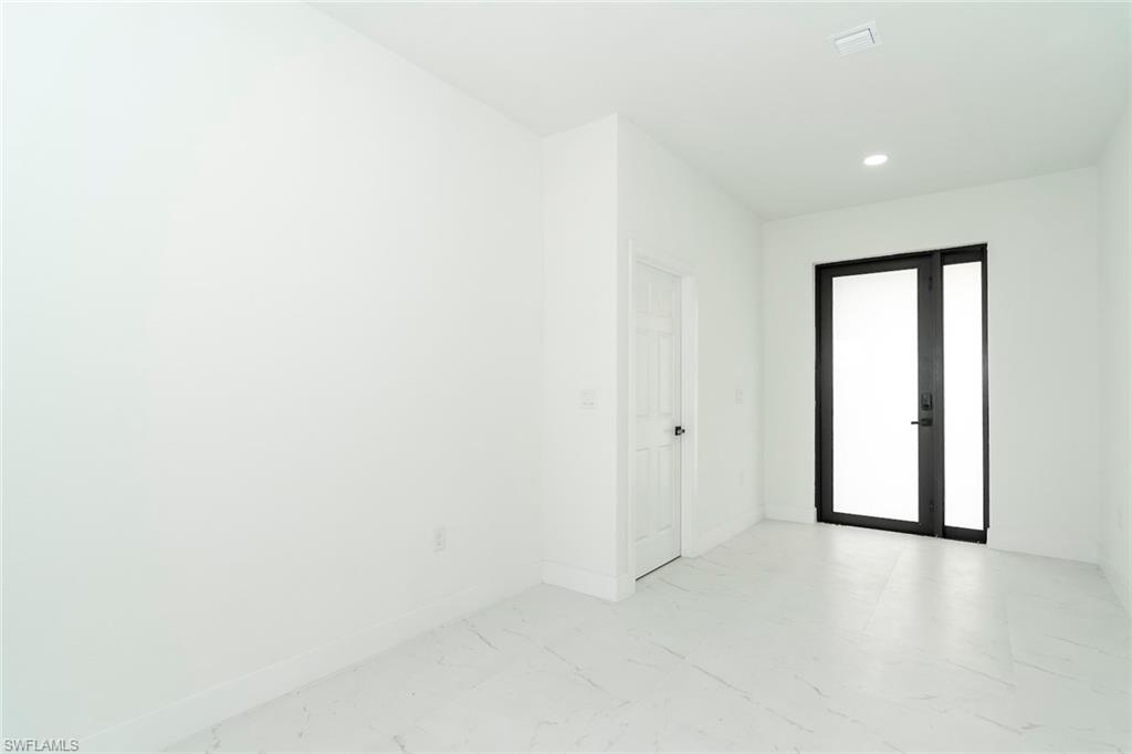 3810 29th Street Southwest Lehigh Acres, FL 33976 - Photo 6 of 48 a view of an empty room with a window