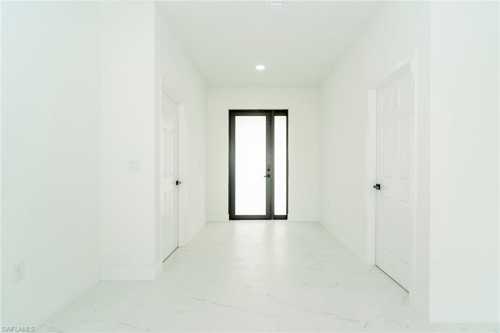 3810 29th Street Southwest Lehigh Acres, FL 33976 - Photo 7 of 48 a view of entryway with wooden floor