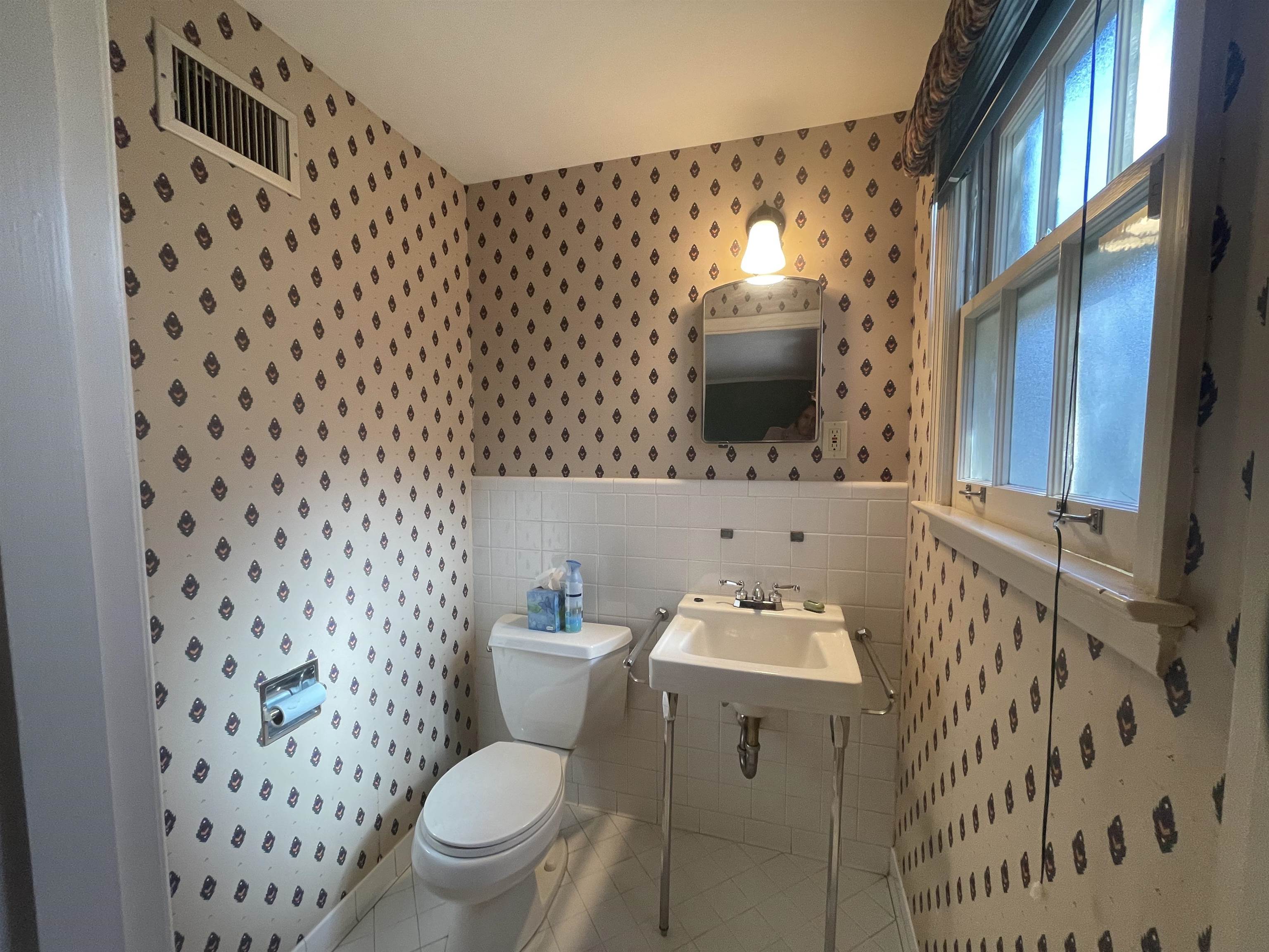 4477 Tall Trees Drive Memphis, TN 38117 - Photo 19 of 25 a bathroom with a sink toilet and mirror