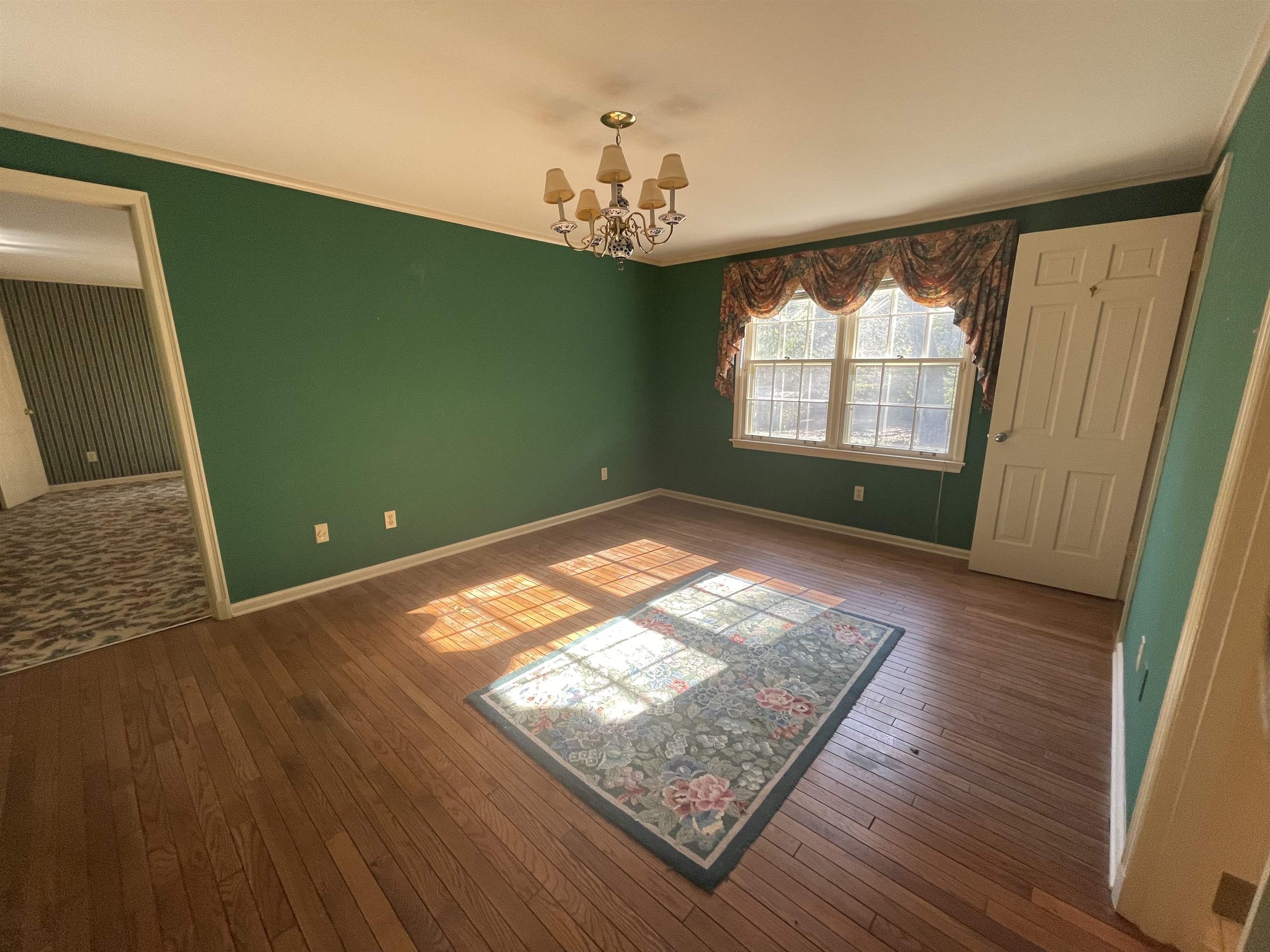 4477 Tall Trees Drive Memphis, TN 38117 - Photo 20 of 25 a view of empty room with window and wooden floor