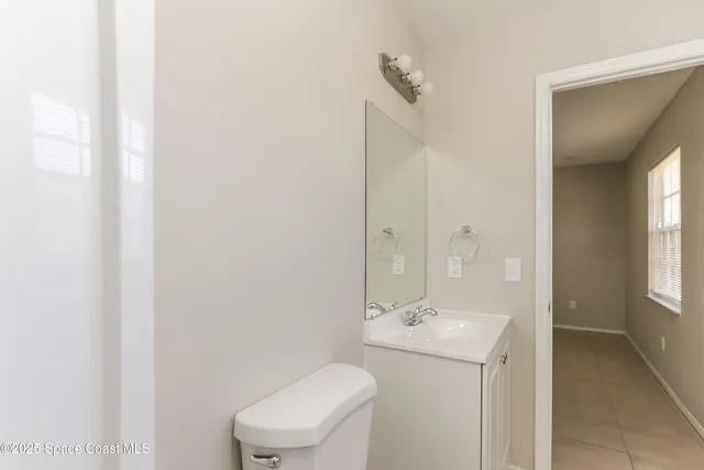 a bathroom with a sink toilet and window