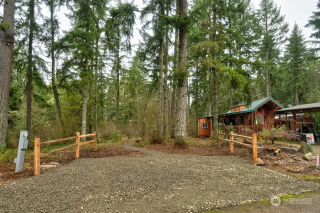 a view of a wooden deck with trees in the background