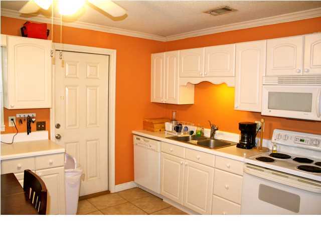 10 Barracuda Street Santa Rosa Beach, FL 32459 - Photo 12 of 14 a kitchen with stainless steel appliances granite countertop a sink stove and refrigerator