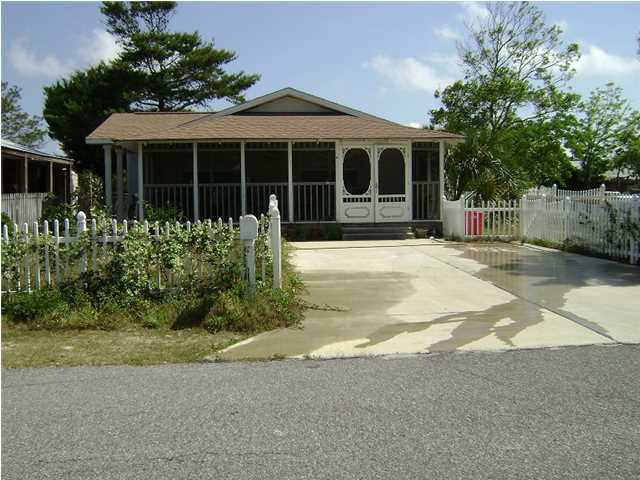 10 Barracuda Street Santa Rosa Beach, FL 32459 - Photo 5 of 14 a front view of a house with a garden and yard