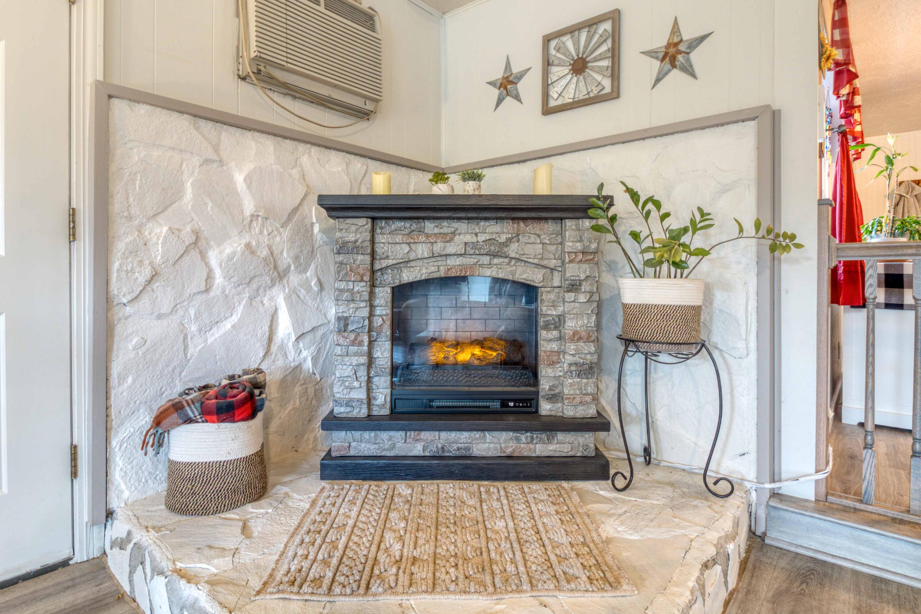 566 Northwest Mc Donald Road Prineville, OR 97754 - Photo 16 of 41 a living room with a fireplace and a potted plant