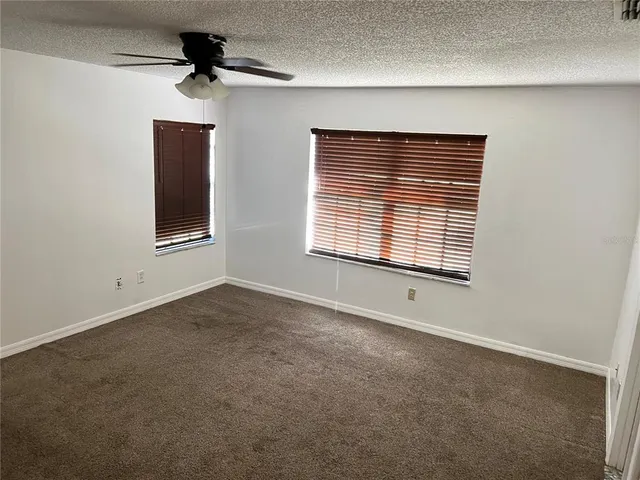 a view of a porch with furniture and backyard