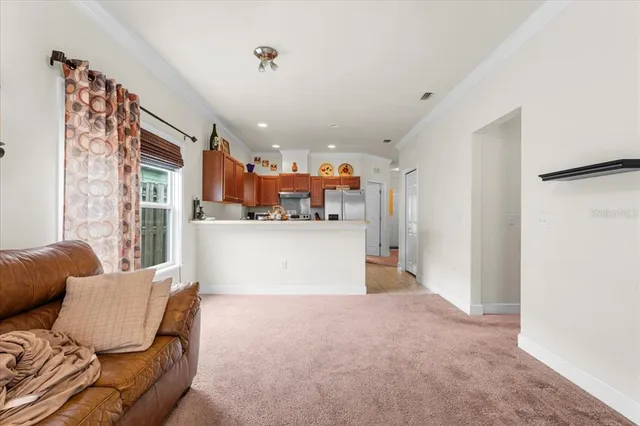 a living room with furniture and a kitchen