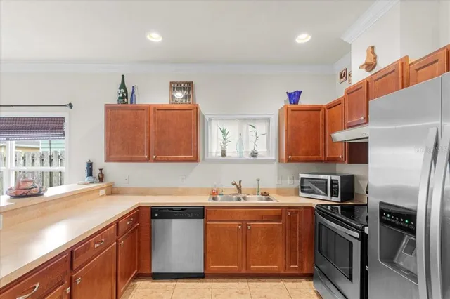 a kitchen with stainless steel appliances granite countertop a refrigerator sink and stove