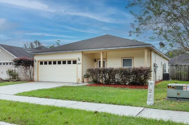a front view of house with yard and green space