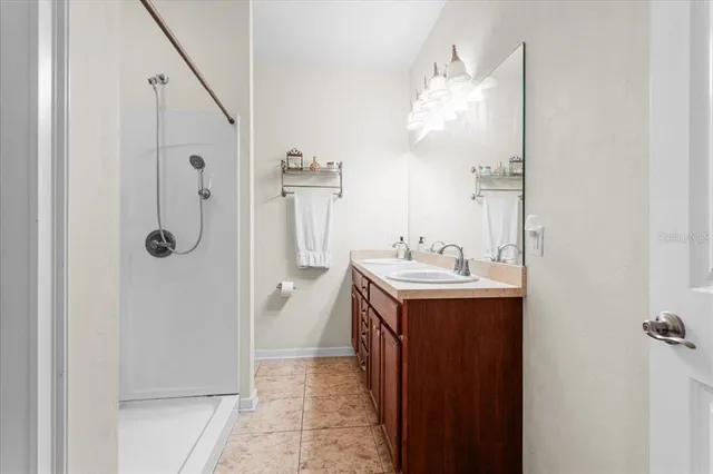 a bathroom with a sink a mirror and shower