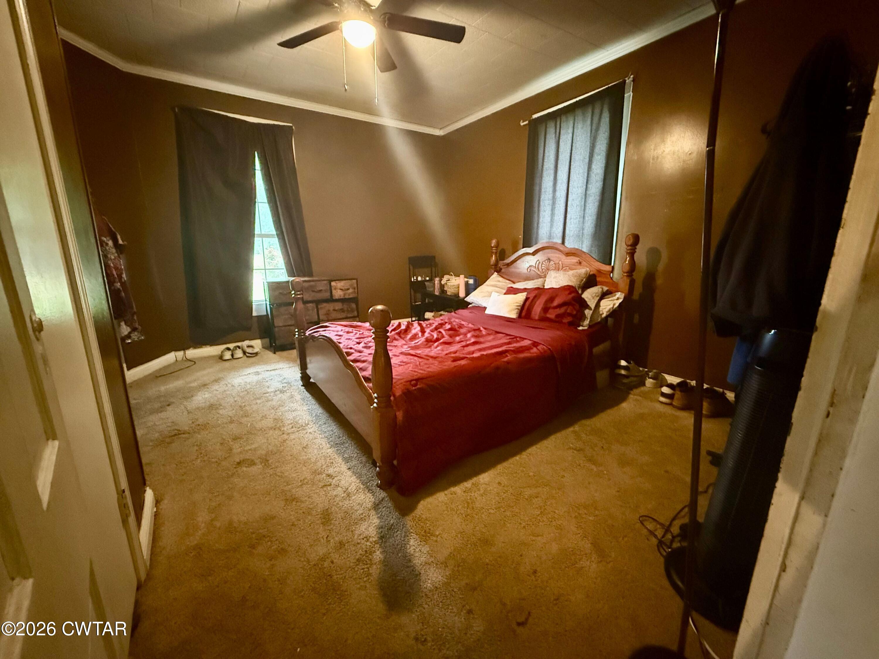 1935 Buster Collins Road Kenton, TN 38233 - Photo 6 of 18 a spacious bedroom with a bed and a chandelier