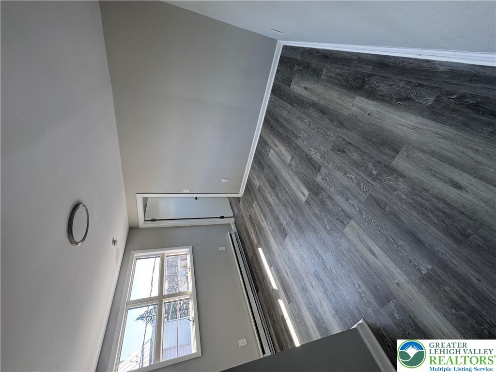 702 Walnut Street, Unit 2 Freeland, PA 18224 - Photo 6 of 8 Clean, new flooring complements the well-lit walls, creating an inviting space with a window offering views.
