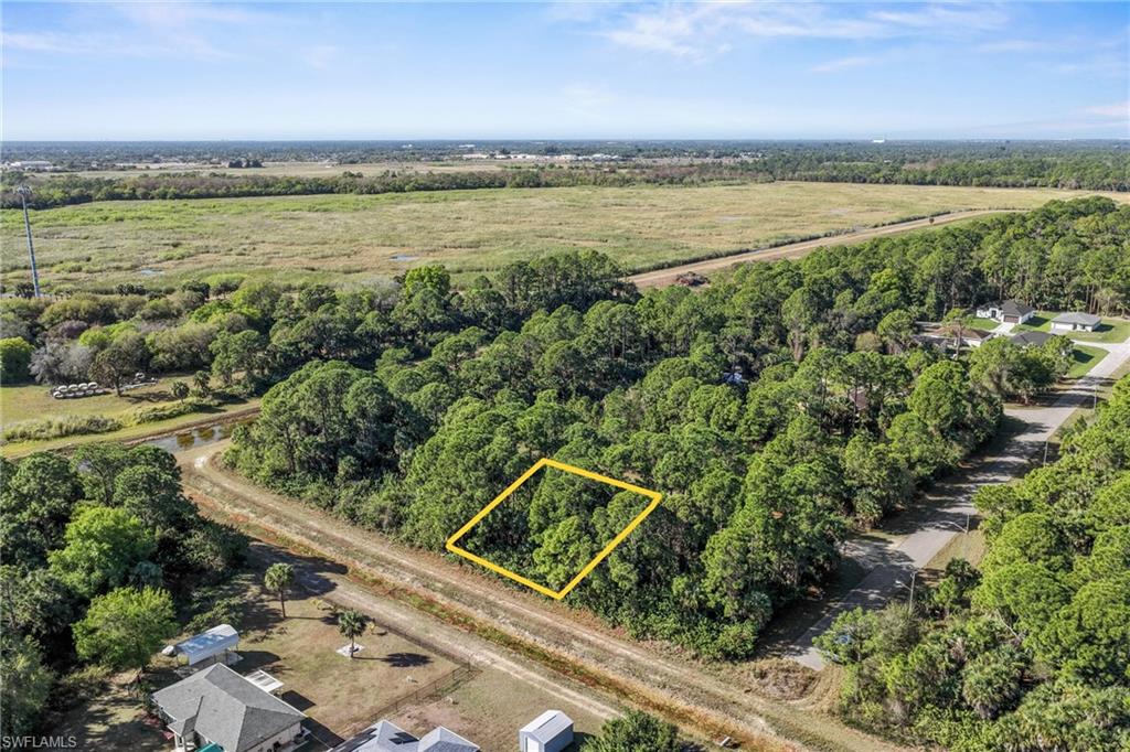 4702 Rita Avenue North Lehigh Acres, FL 33971 - Photo 6 of 15 a view of a lake from a yard